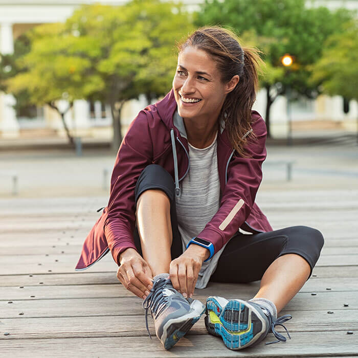 woman getting ready for a run in city park