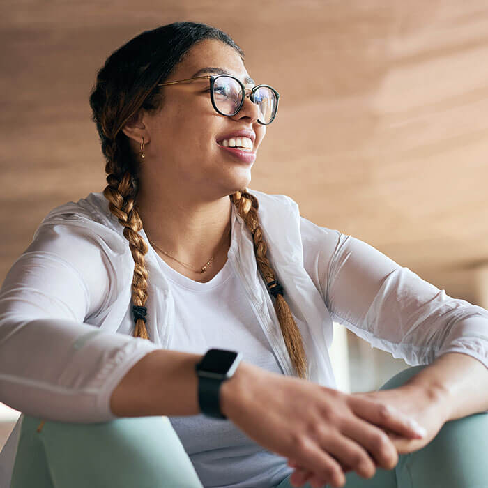 woman sitting and smiling while looking to the side