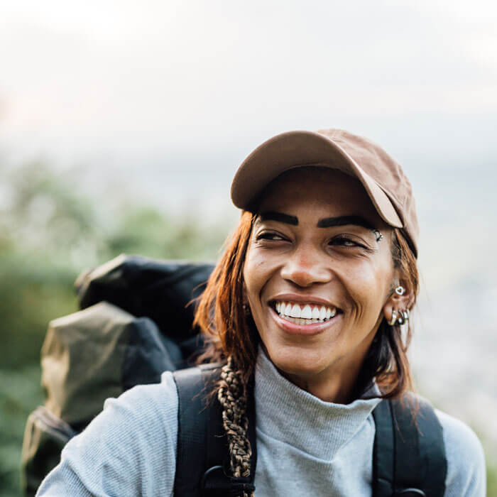 smiling woman on a hike outdoors