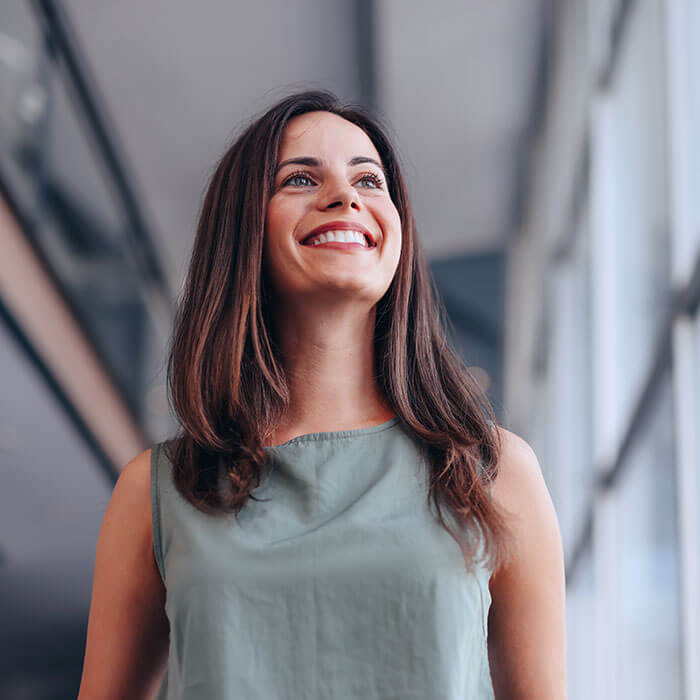 woman smiling and looking upward