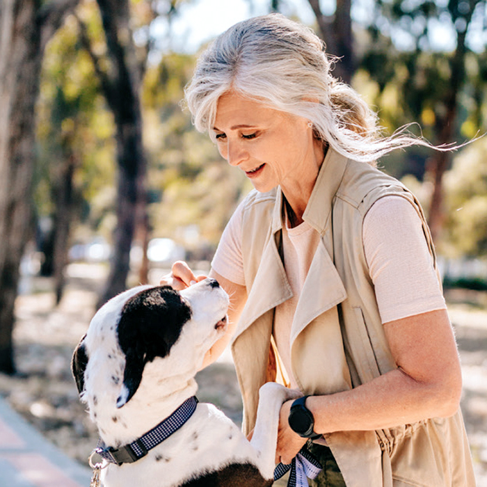 Senior woman in the park with dog