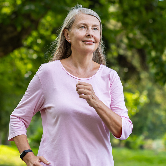 Senior mature woman running in the park
