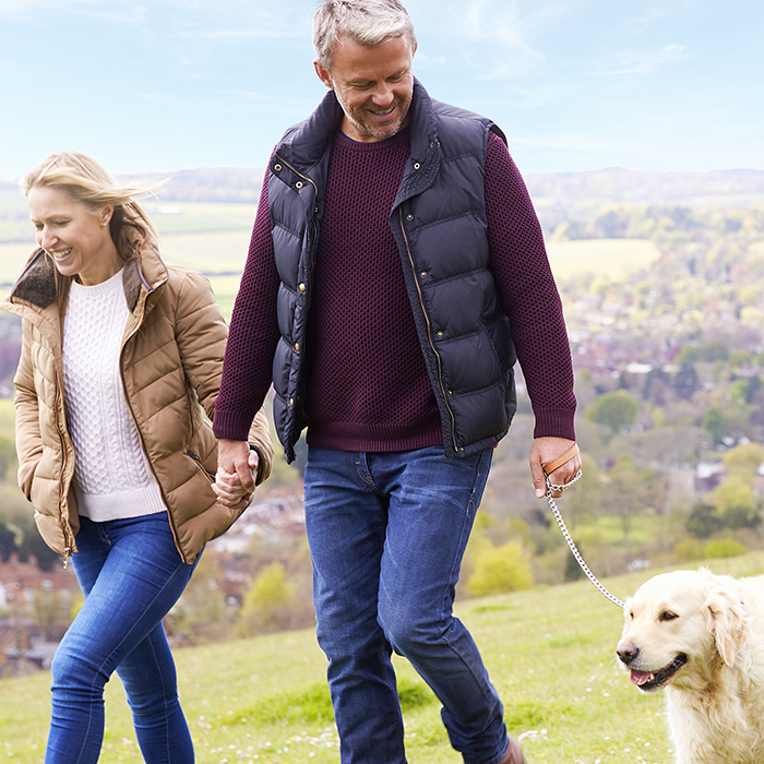 Couple taking their dog for a walk