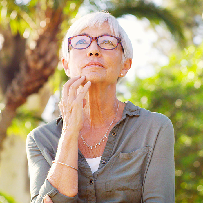 Senior woman looking thoughtful at the park