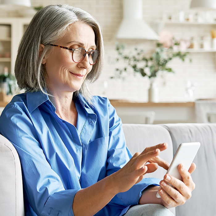 Mature senior woman using smartphone